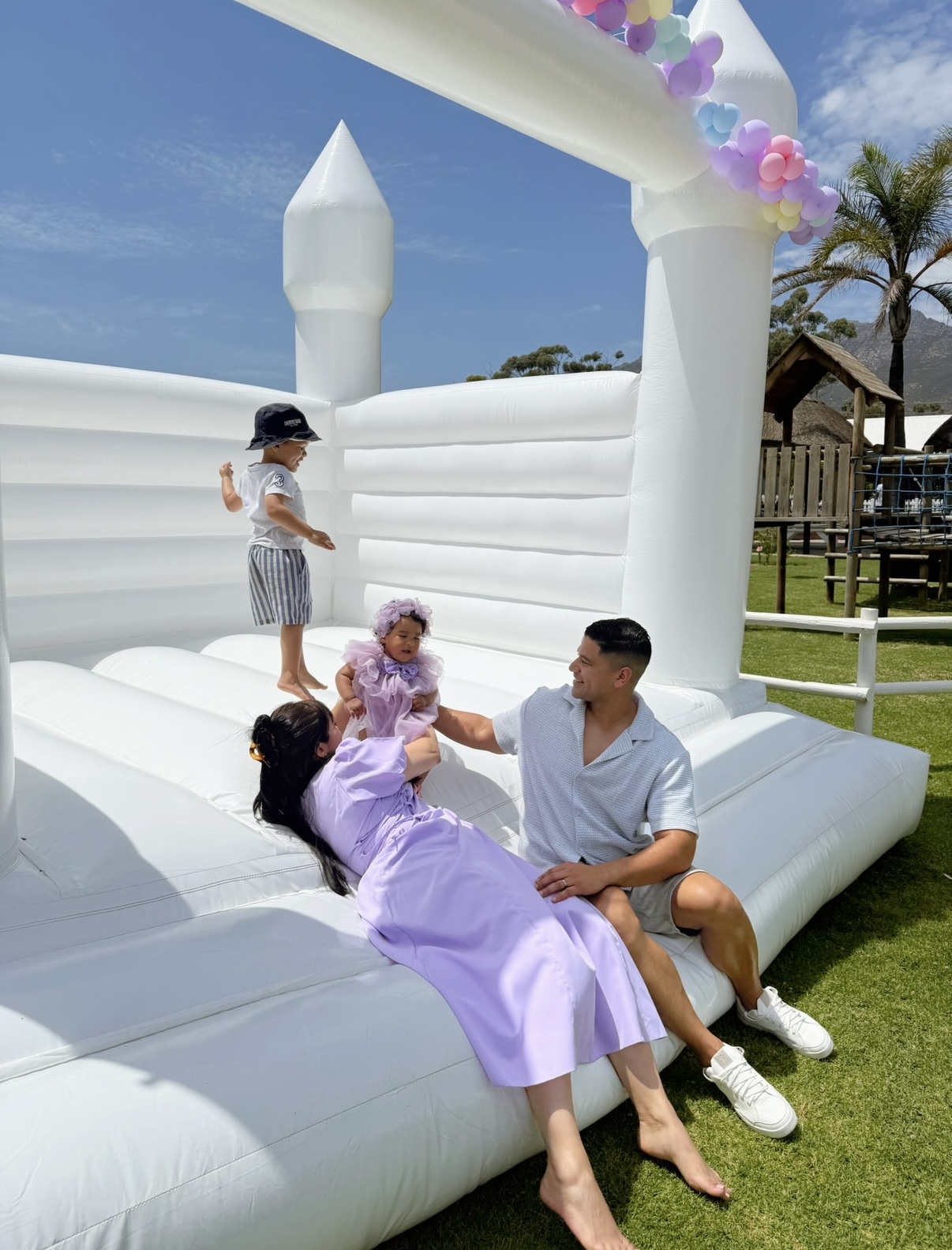 Founder Dhilshaad Moses and her family enjoying a white jumping castle