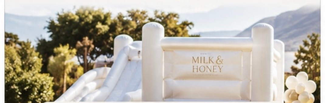 White Milk & Honey jumping castle with slide set up on a lawn